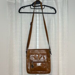 Brown leather crossbody bag with zipper closure and multiple pockets